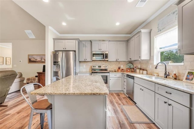 210 Riverpoint Way, Jackson, GA 30233 - kitchen with stainless steel appliances, a sink, gray cabinetry, a kitchen island, and crown molding