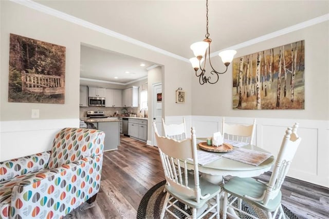 210 Riverpoint Way, Jackson, GA 30233 - dining space featuring ornamental molding, dark wood-style flooring, a chandelier, a wainscoted wall, and recessed lighting
