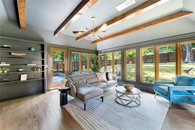 sunroom featuring beamed ceiling and a notable chandelier