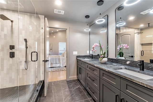 bathroom with vanity and a shower with door