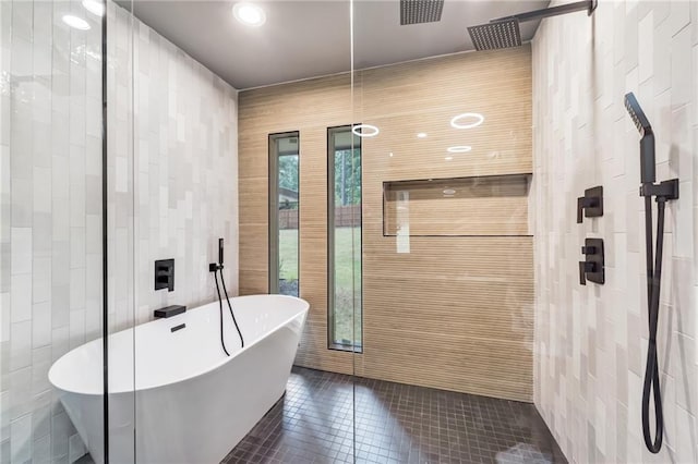 bathroom featuring tile patterned flooring, shower with separate bathtub, and tile walls