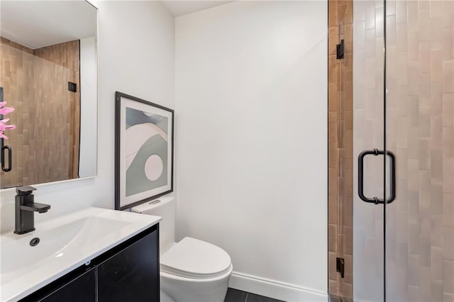 bathroom with vanity, toilet, and a shower with door