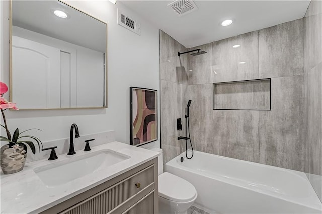 full bathroom featuring vanity, toilet, and tiled shower / bath