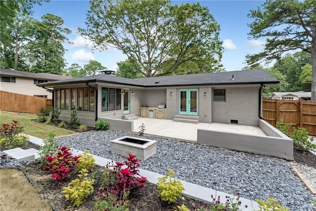 rear view of property featuring a patio area and french doors