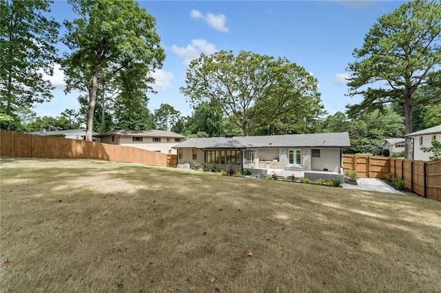 rear view of house with a lawn