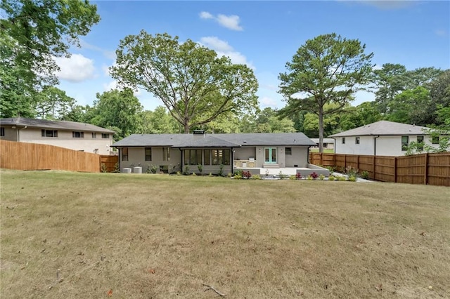 rear view of property featuring a yard