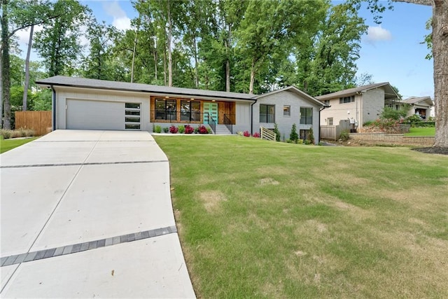 single story home with covered porch, a front yard, and a garage