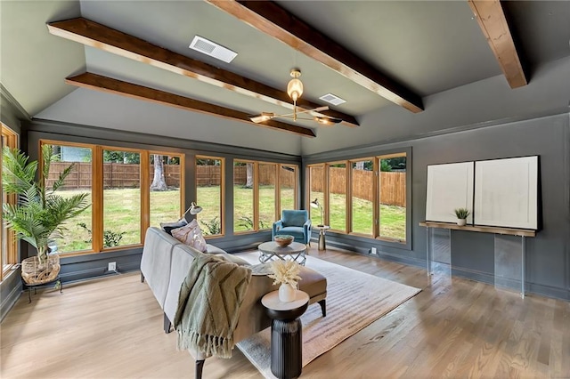 sunroom / solarium featuring beam ceiling