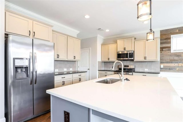 kitchen featuring appliances with stainless steel finishes, crown molding, sink, decorative light fixtures, and cream cabinetry