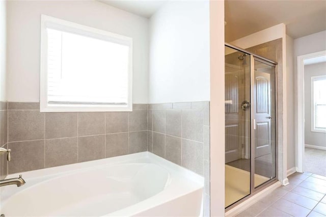 bathroom with tile patterned floors and separate shower and tub