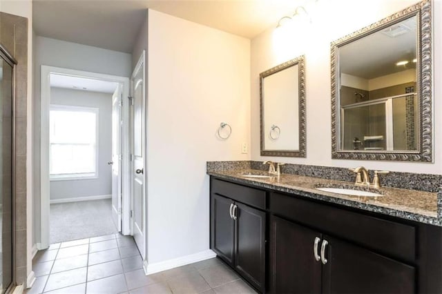 bathroom featuring tile patterned flooring, vanity, and a shower with door