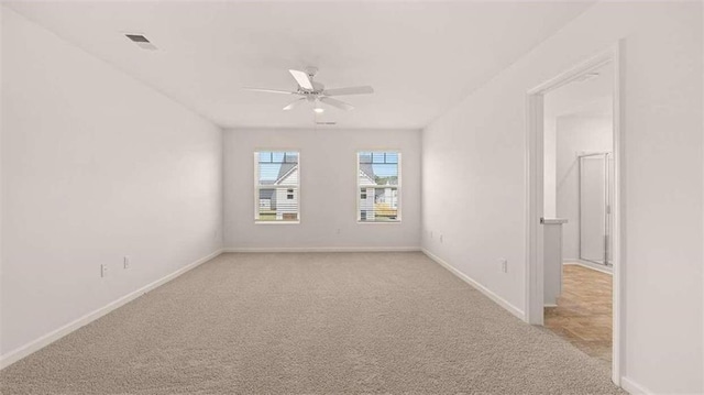 spare room featuring ceiling fan and light colored carpet