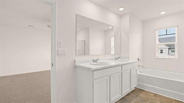 bathroom featuring vanity and a tub to relax in