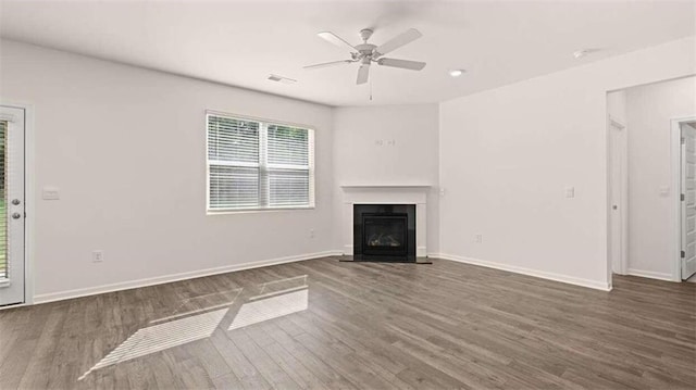 unfurnished living room with ceiling fan and dark hardwood / wood-style floors