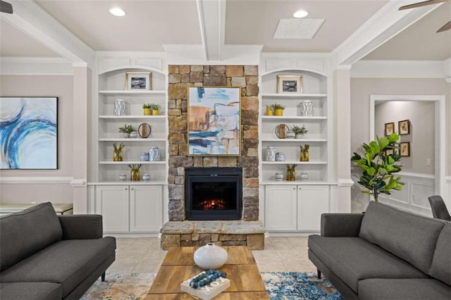 tiled living room with ornamental molding, ceiling fan, built in features, and a fireplace