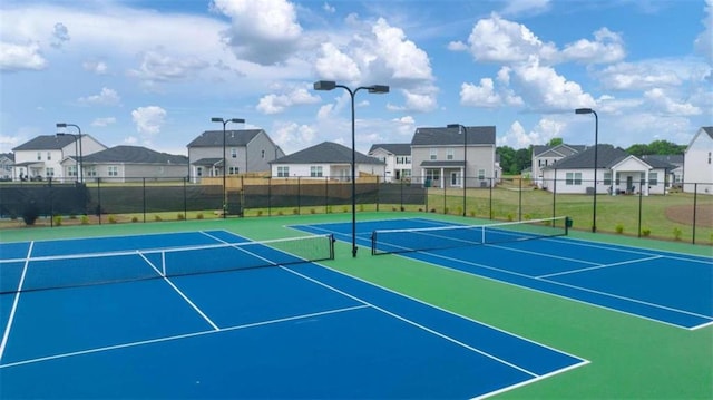 view of tennis court with basketball hoop