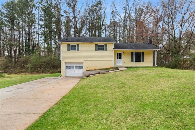 split level home featuring a garage and a front yard