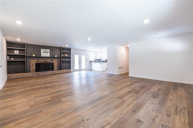 96 Sam Alexander Rd, Douglasville, GA 30134 - unfurnished living room featuring baseboards, wood finished floors, built in features, and recessed lighting