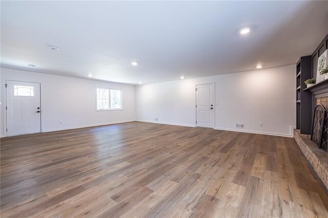 96 Sam Alexander Rd, Douglasville, GA 30134 - unfurnished living room featuring baseboards, a fireplace, and wood finished floors