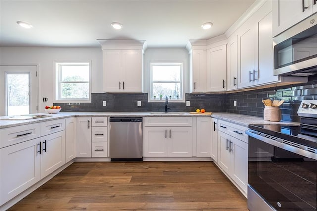 96 Sam Alexander Rd, Douglasville, GA 30134 - kitchen with decorative backsplash, appliances with stainless steel finishes, dark wood-type flooring, white cabinetry, and a sink