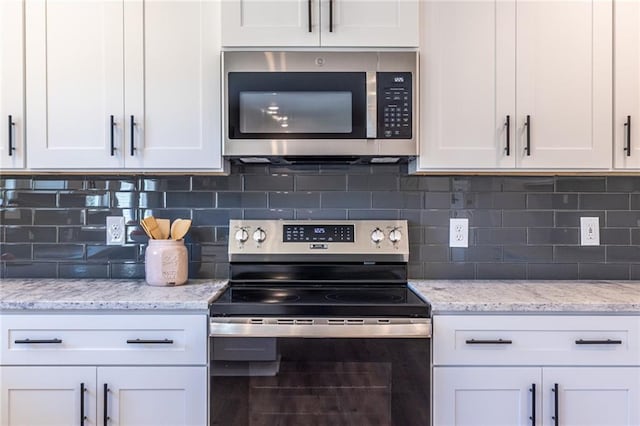 96 Sam Alexander Rd, Douglasville, GA 30134 - kitchen featuring white cabinets, tasteful backsplash, and stainless steel appliances