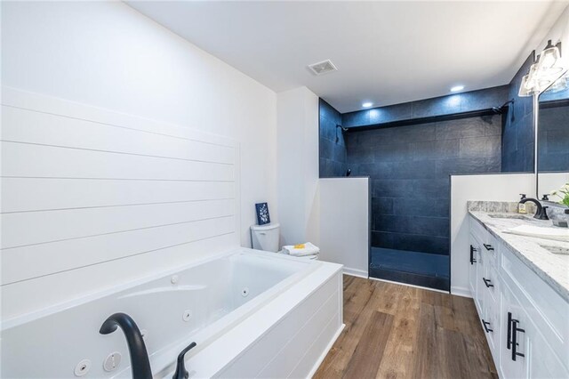 96 Sam Alexander Rd, Douglasville, GA 30134 - full bath featuring a walk in shower, a sink, a jetted tub, visible vents, and wood finished floors