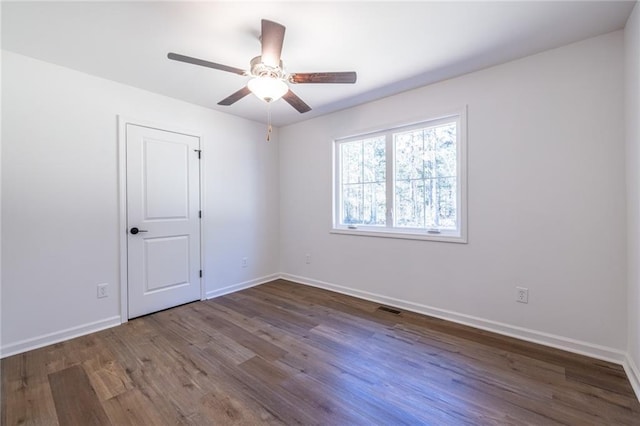 96 Sam Alexander Rd, Douglasville, GA 30134 - spare room with baseboards, visible vents, dark wood-type flooring, and a ceiling fan