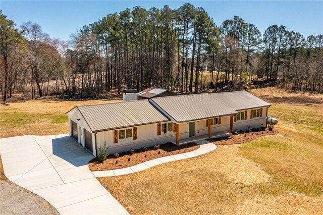 96 Sam Alexander Rd, Douglasville, GA 30134 - ranch-style home with metal roof, driveway, a front lawn, a porch, and a chimney