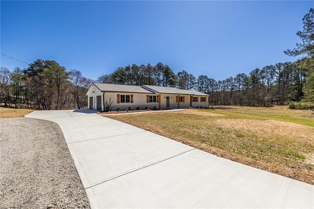 96 Sam Alexander Rd, Douglasville, GA 30134 - ranch-style home with a front yard, a garage, and concrete driveway