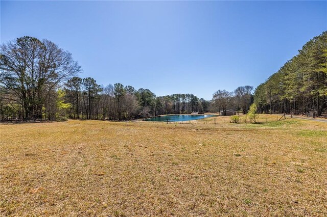96 Sam Alexander Rd, Douglasville, GA 30134 - view of yard featuring an outdoor pool and a wooded view