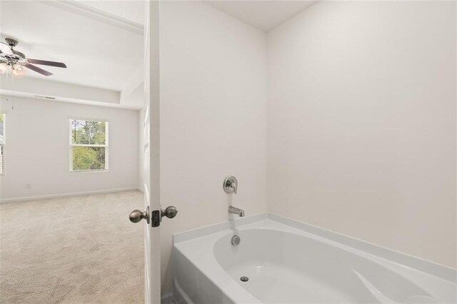 bathroom with a bathing tub and ceiling fan