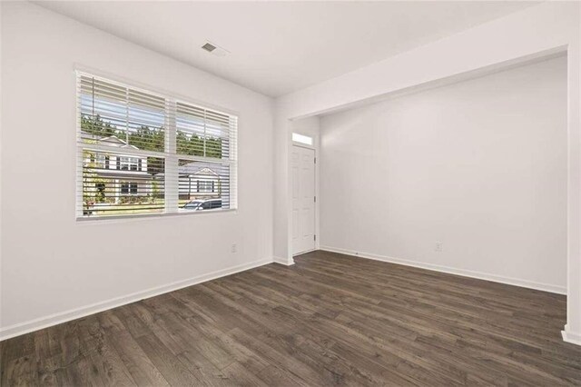 empty room featuring dark wood-type flooring