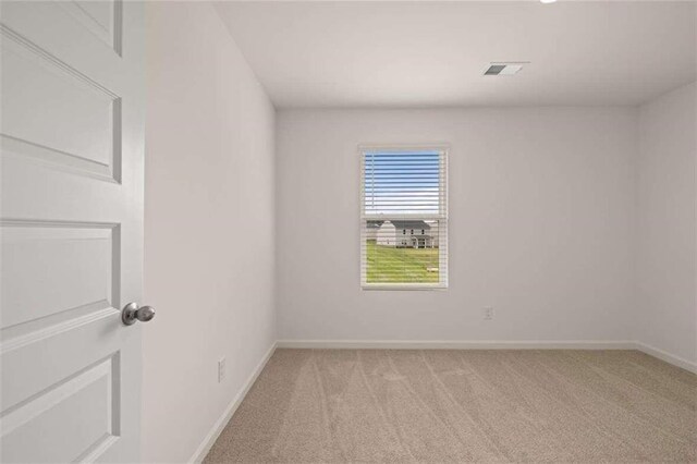 unfurnished room with light colored carpet