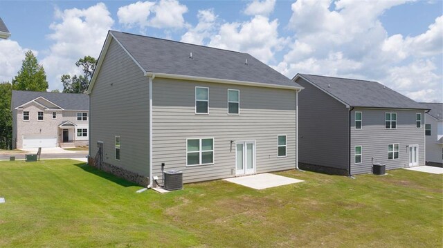 rear view of house featuring a lawn, a patio area, and central air condition unit