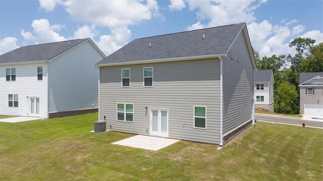 rear view of house with a yard, a patio, and central air condition unit