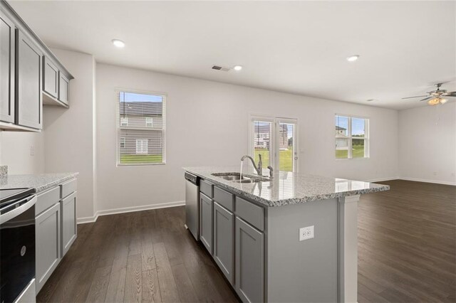 kitchen featuring gray cabinets, light stone counters, stainless steel appliances, and sink