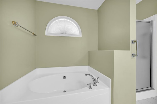 bathroom with a garden tub and a stall shower