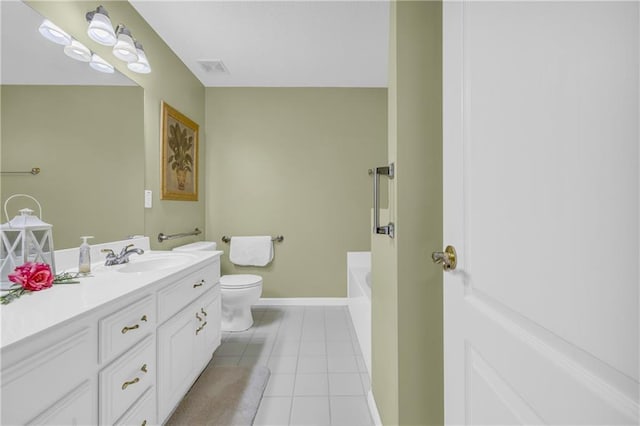 full bath with tile patterned flooring, toilet, baseboards, vanity, and a tub to relax in