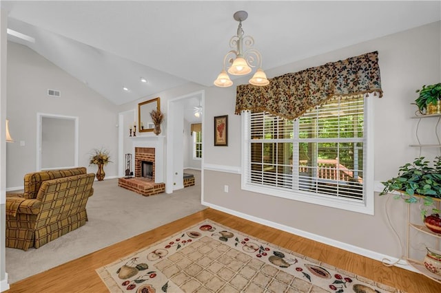 living room with wood finished floors, lofted ceiling, and baseboards