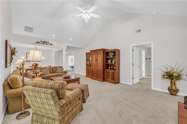living area featuring high vaulted ceiling, ceiling fan, light colored carpet, and baseboards