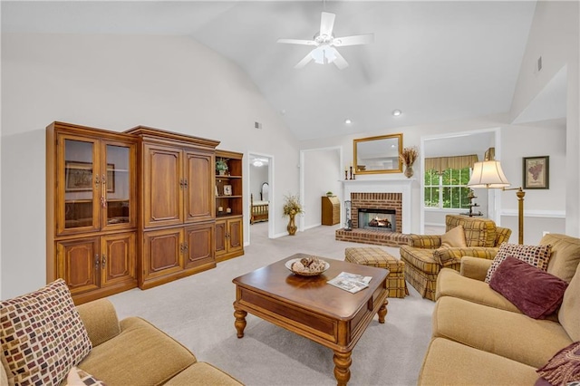 living area featuring high vaulted ceiling, ceiling fan, a fireplace, light colored carpet, and recessed lighting