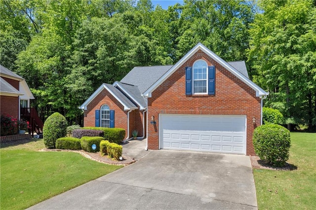 traditional-style home featuring driveway, brick siding, a front yard, and an attached garage