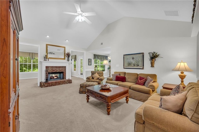 carpeted living area with ceiling fan, a fireplace, high vaulted ceiling, and recessed lighting