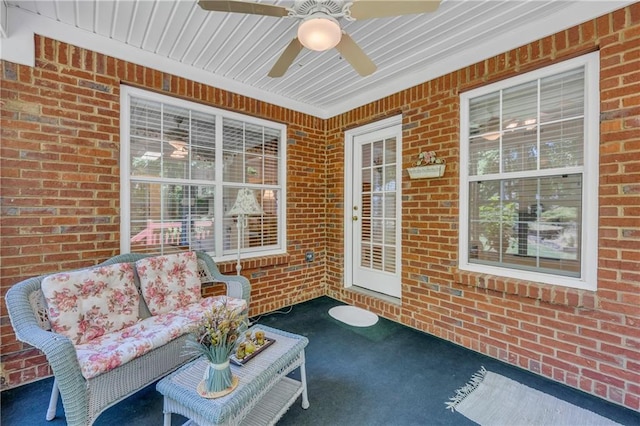 sunroom / solarium featuring a ceiling fan