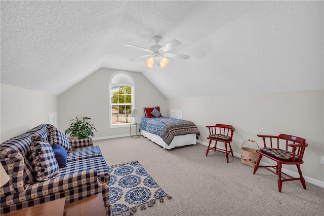 carpeted bedroom with a textured ceiling, lofted ceiling, a ceiling fan, and baseboards