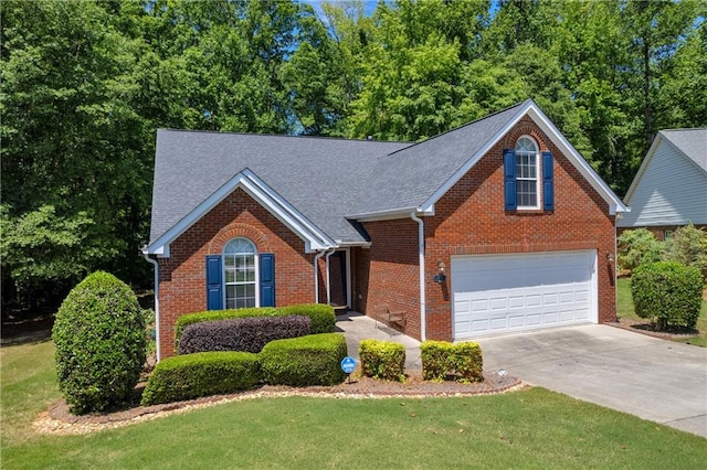 traditional-style house featuring brick siding, concrete driveway, a front lawn, and roof with shingles