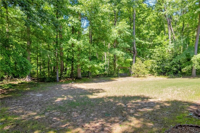 view of yard featuring a forest view