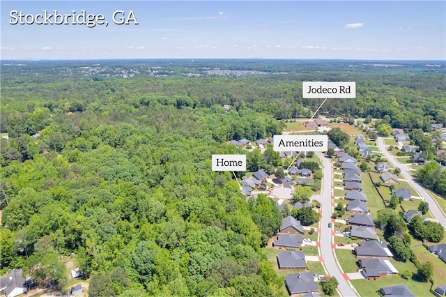 aerial view of residential area featuring a heavily wooded area