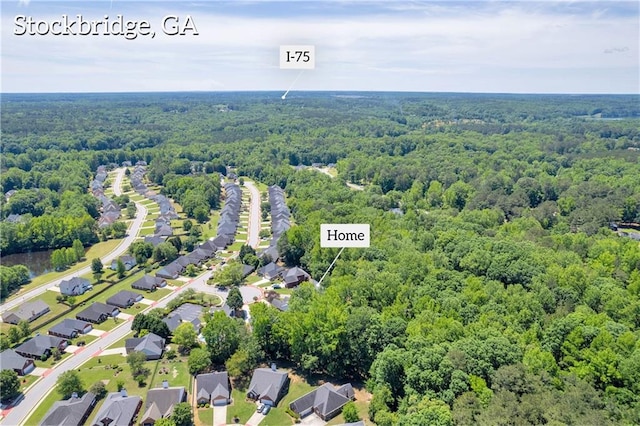 aerial perspective of suburban area featuring a forest