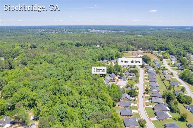aerial perspective of suburban area featuring a forest